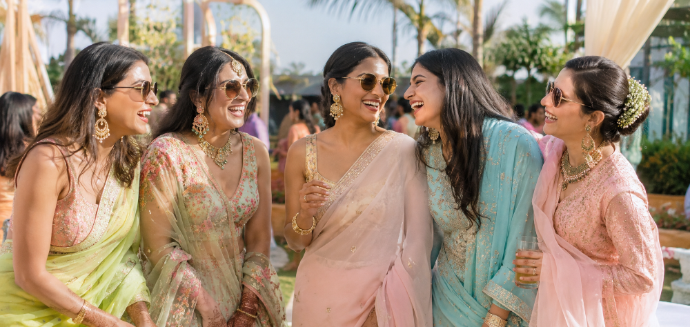 Group of stylish guests demonstrating what to wear to an Indian wedding daytime event